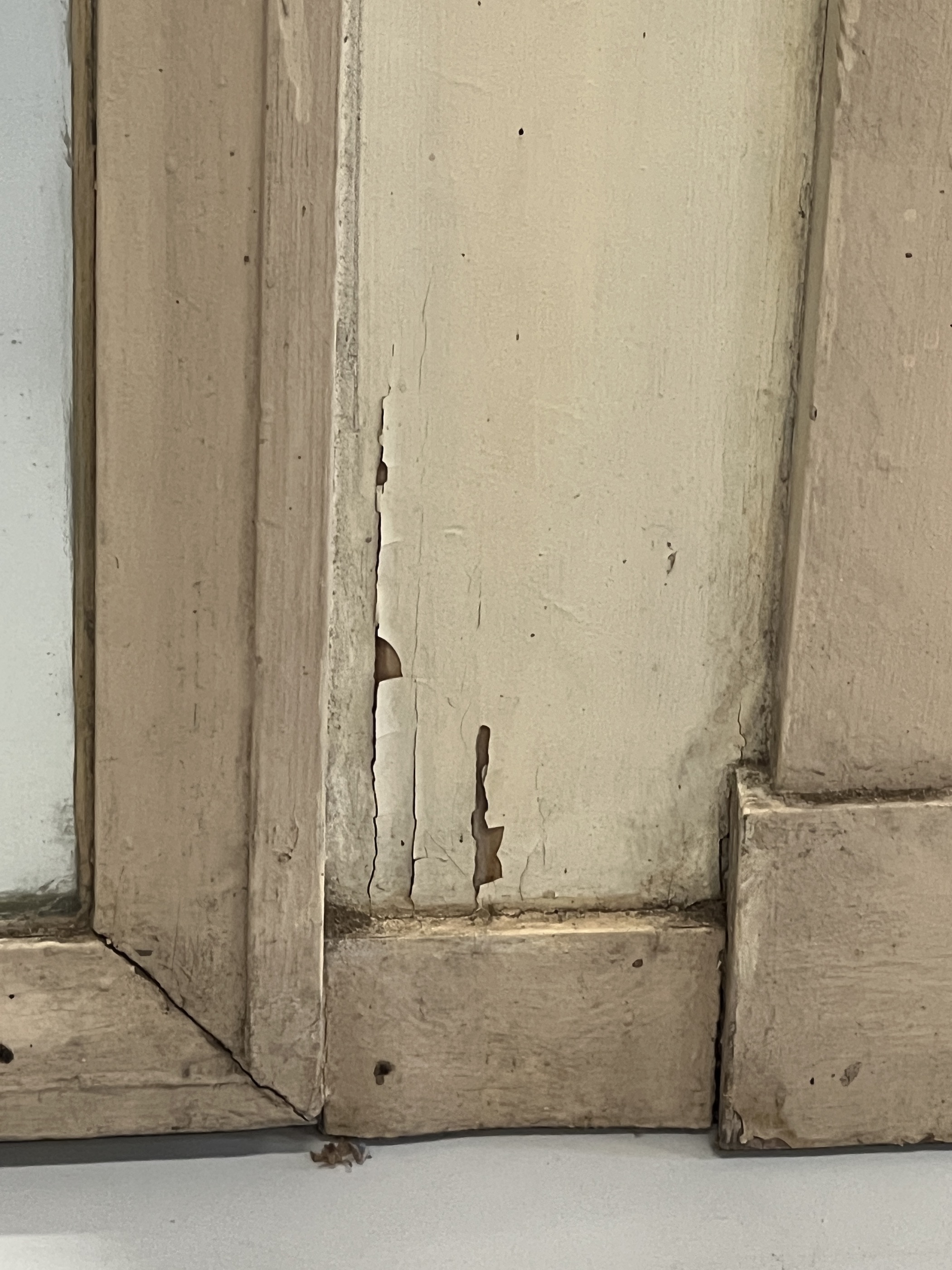 A late 18th/early 19th century French painted pine overmantel mirror modelled as an arched doorway, width 119cm, height 147cm